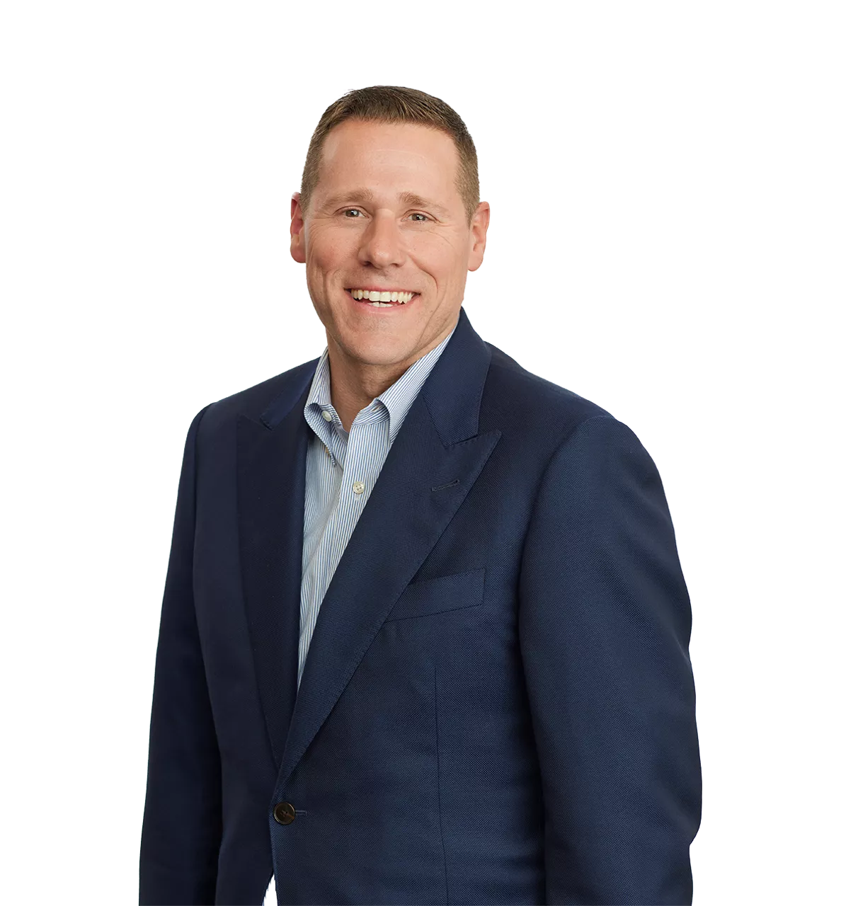 smiling man in a blue suit jacket and light blue shirt standing against a plain white background.