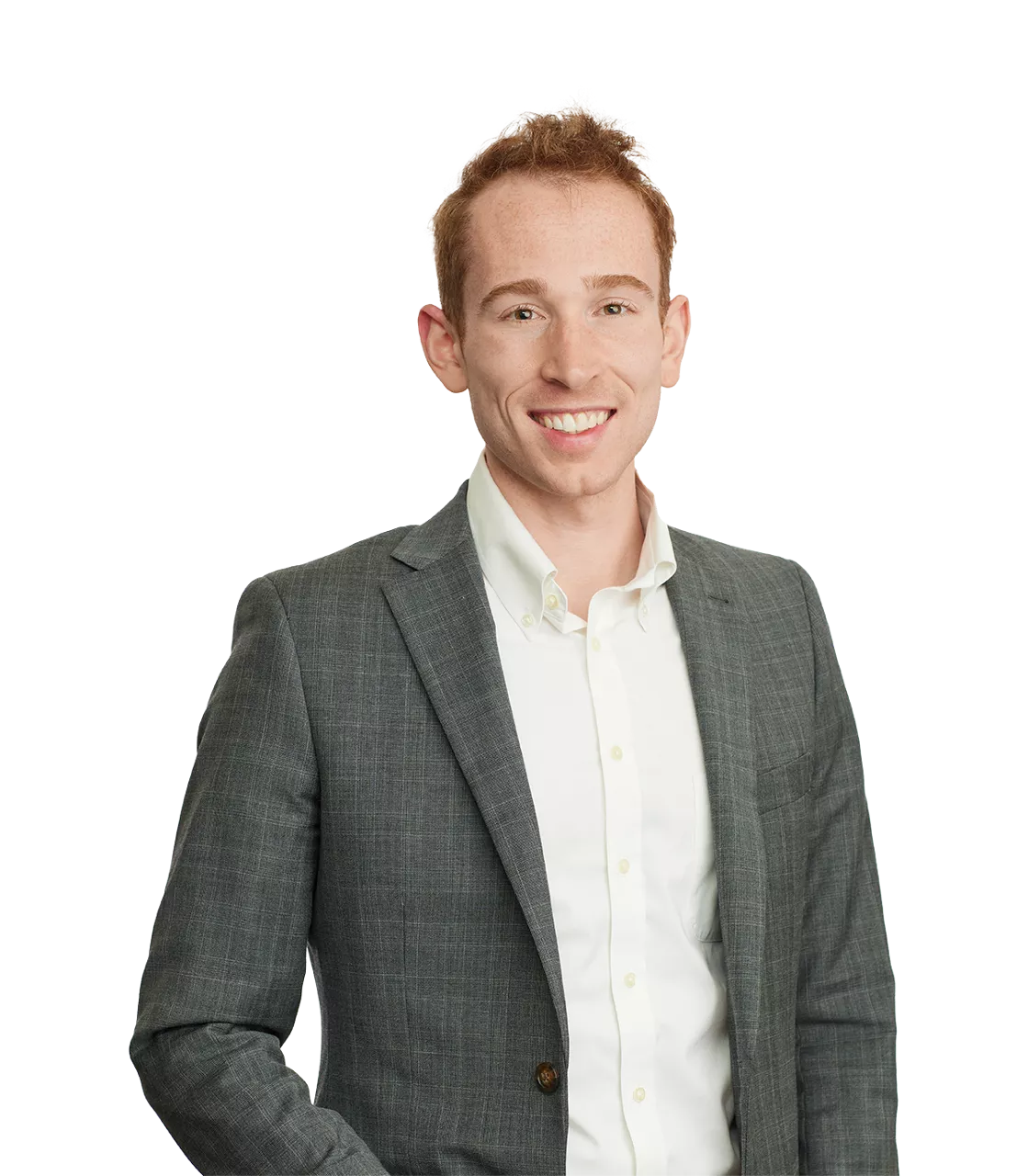 smiling person in a gray suit jacket and white shirt, standing against a plain white background.