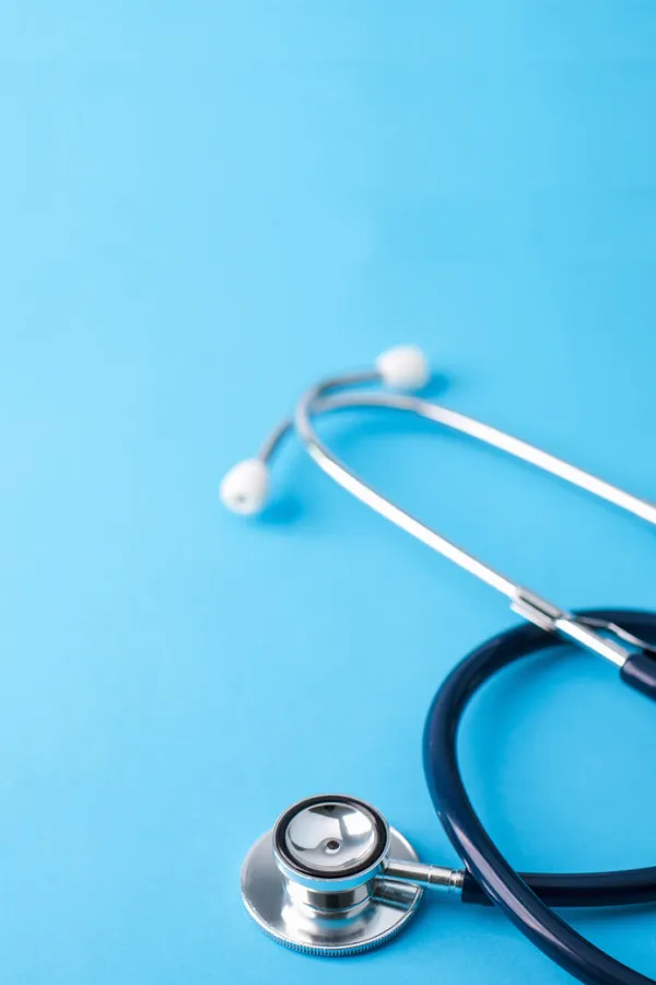 close up of a stethoscope laying on a blue surface