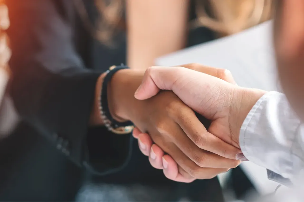 two people shake hands after business services agreement