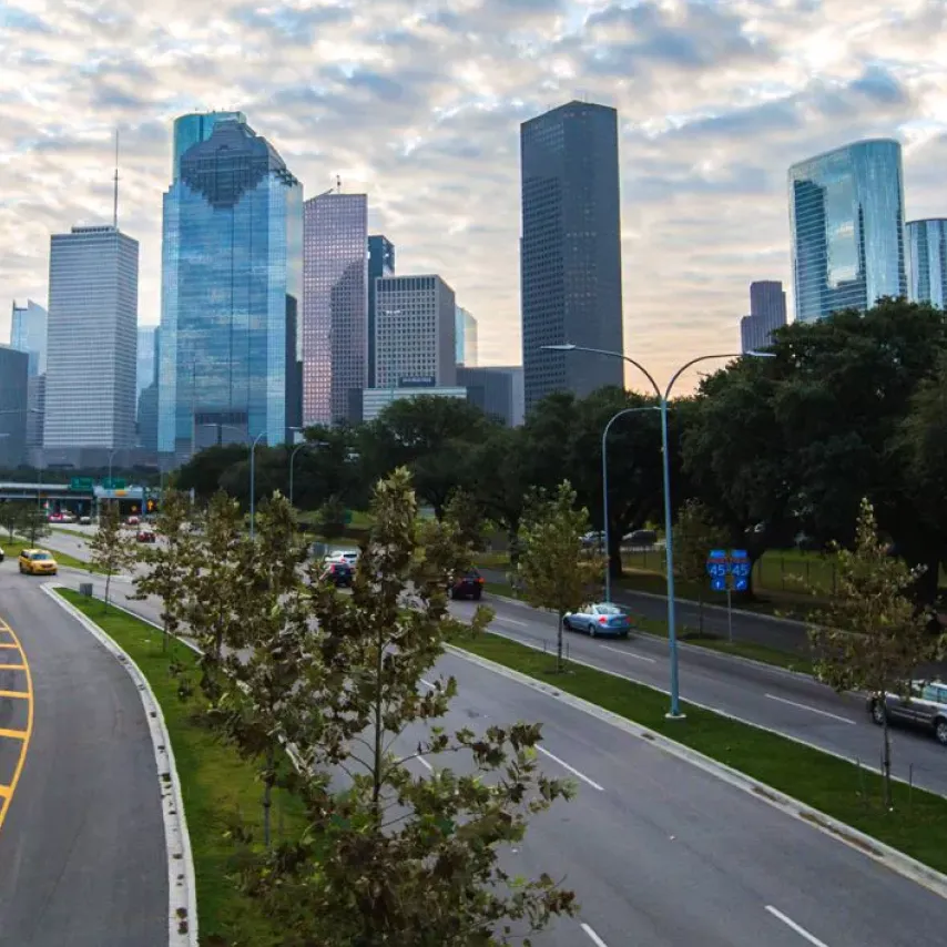 city of Houston skyscraper skyline from highway entering city.