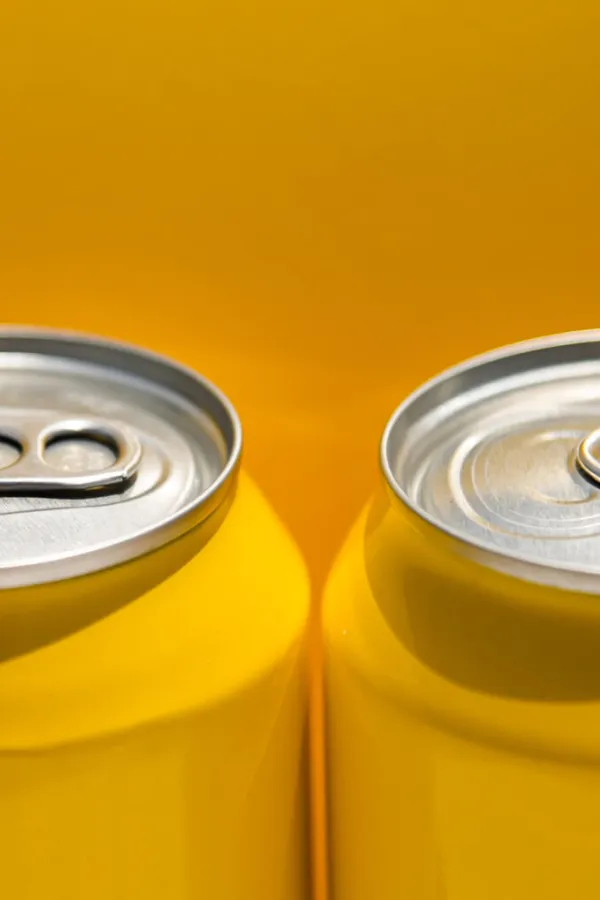 close up of yellow carbonated drink cans