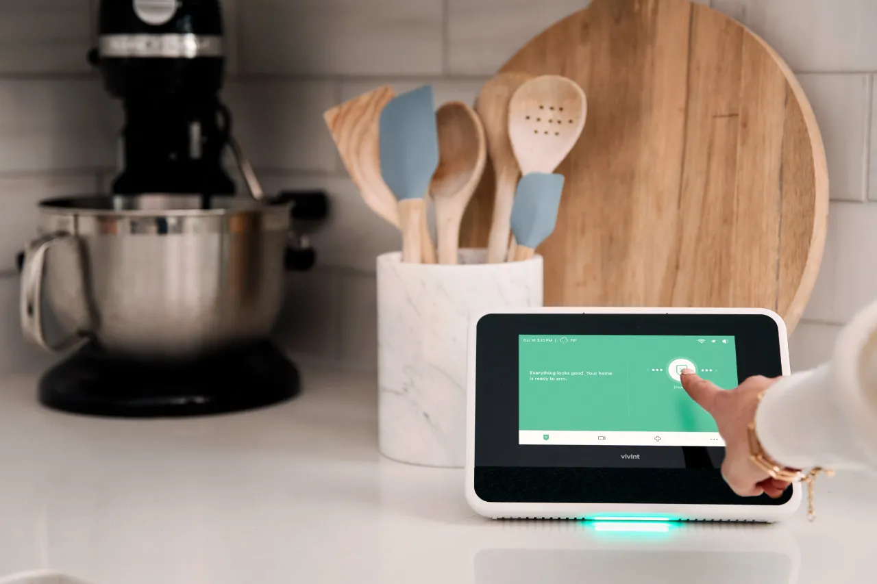 hand on arm disarm screen of Vivint smart hub.