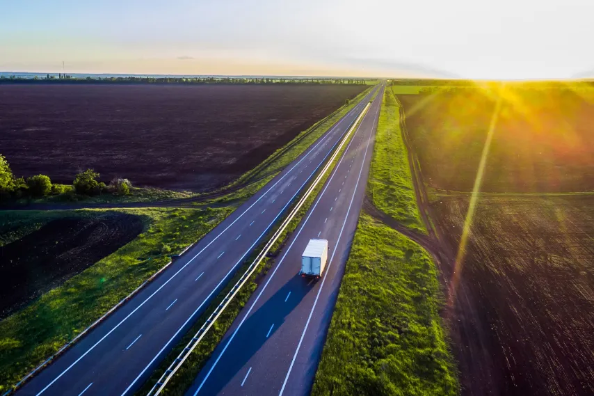 farmland-fields-with-road-running-through-landscape-at-sunrise