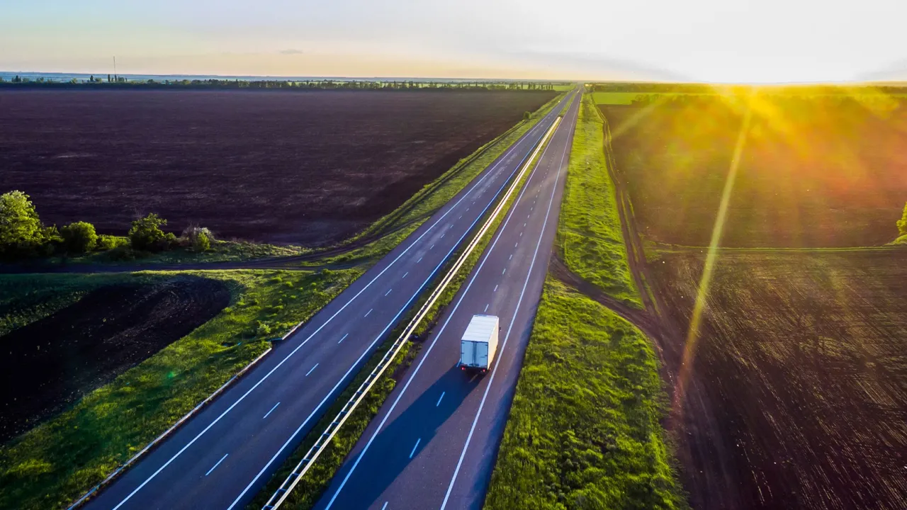 farmland-fields-with-road-running-through-landscape-at-sunrise