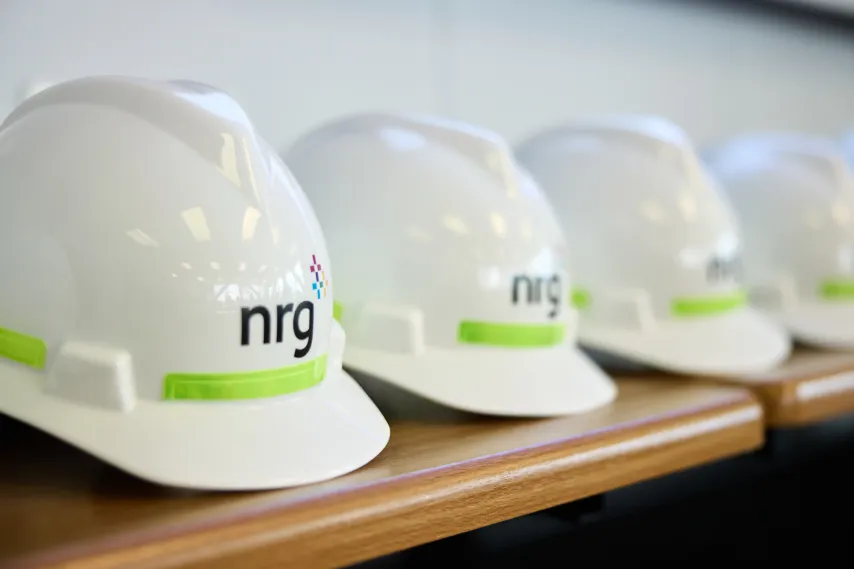 nrg-energy-powerplant-hardhats-lined-up-on-shelf