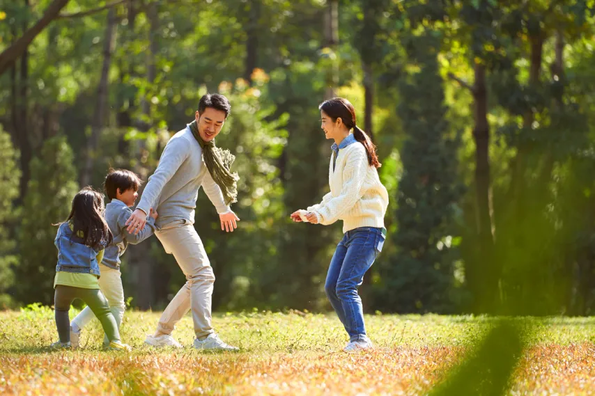 family playing together in a park.