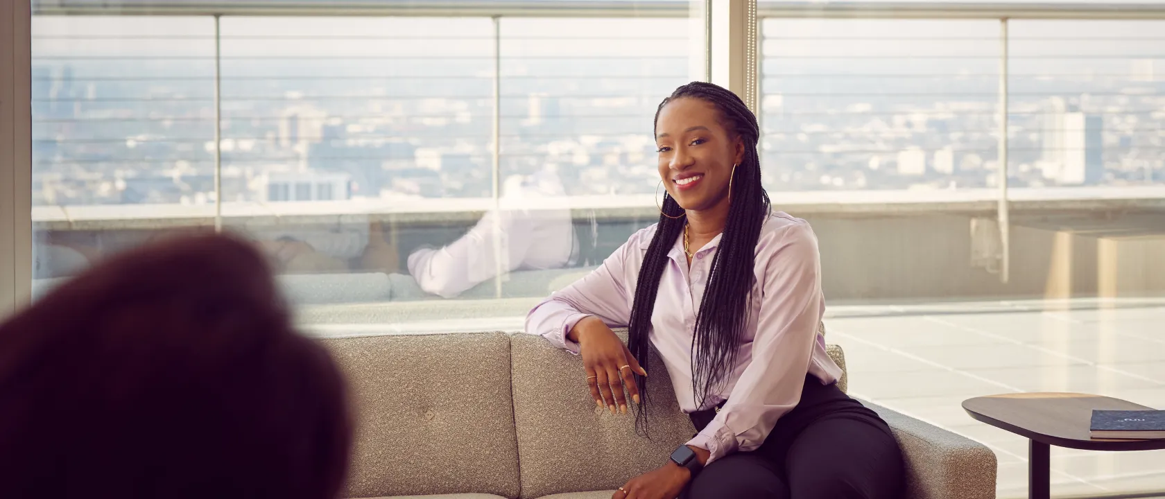 confident-business-woman-smiles-candidly-mid-conversation-with-a-coworker