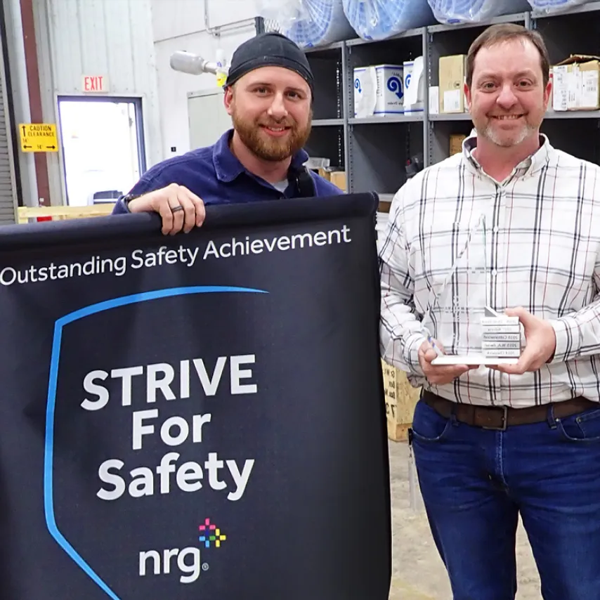 Plum Point Energy Station employees with strive for safety banner award.