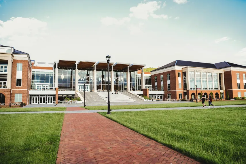 campus commons building with students walking outside.