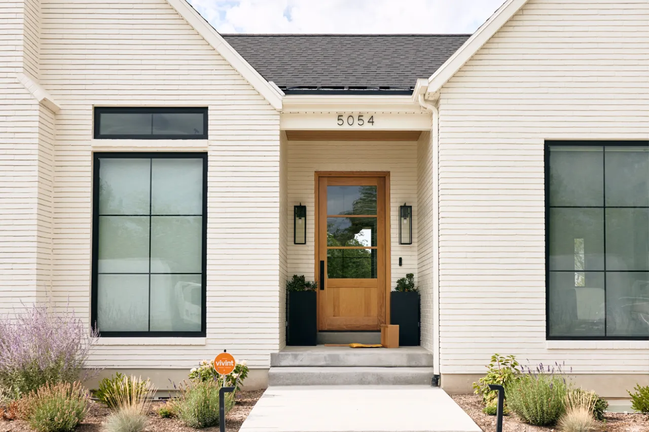 front porch of house with wooden front door and delivered packages.