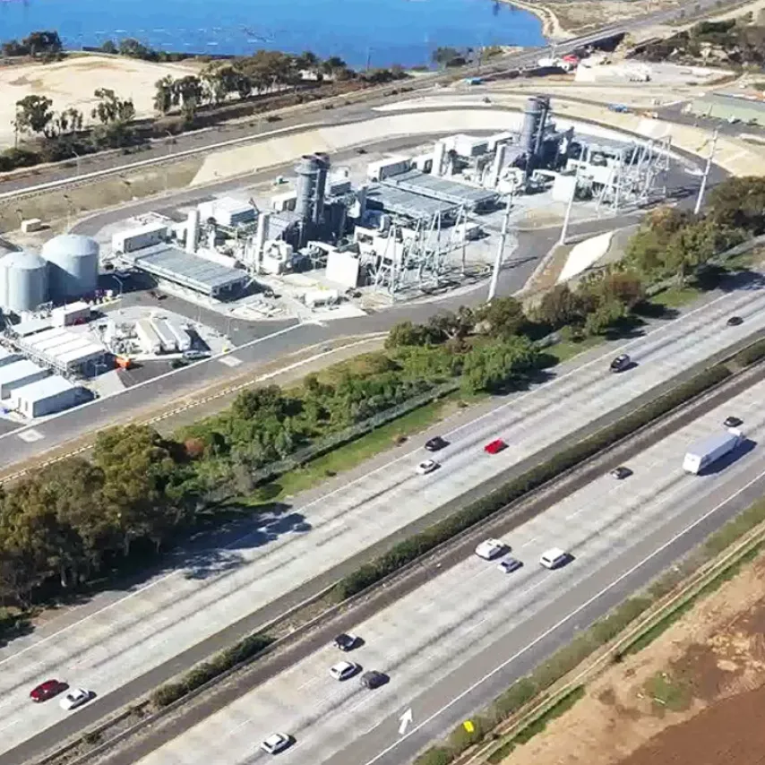 side ariel view of Carlsbad plant next to highway.