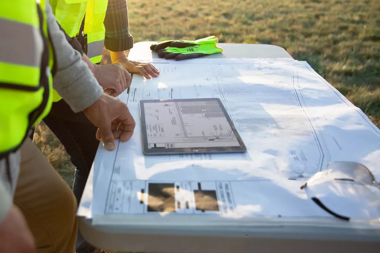 solar farm plans on paper and tablet.