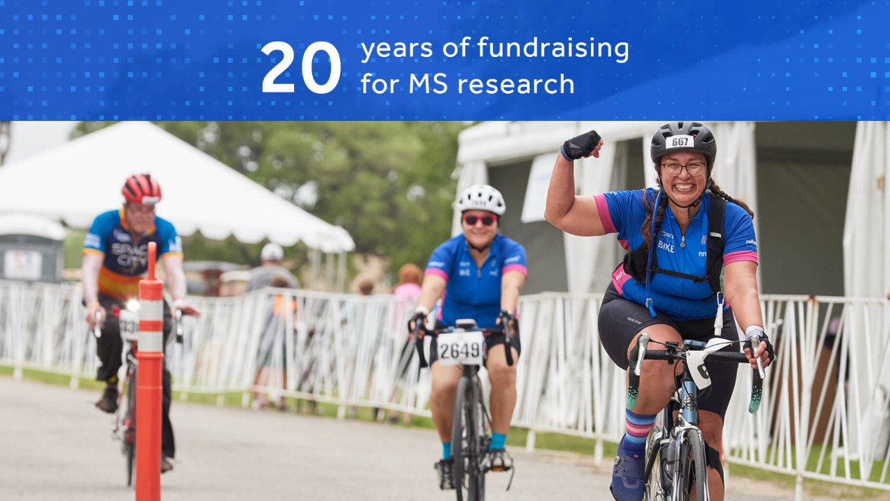 cyclists celebrate at an outdoor event for 20 years of fundraising for MS research.