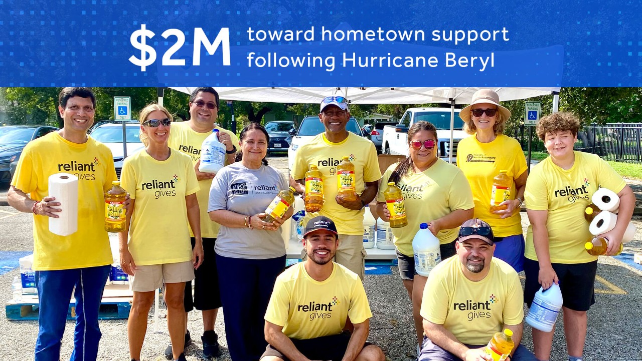 group in yellow shirts holding supplies, under banner about $2M hometown support after Hurricane Beryl.