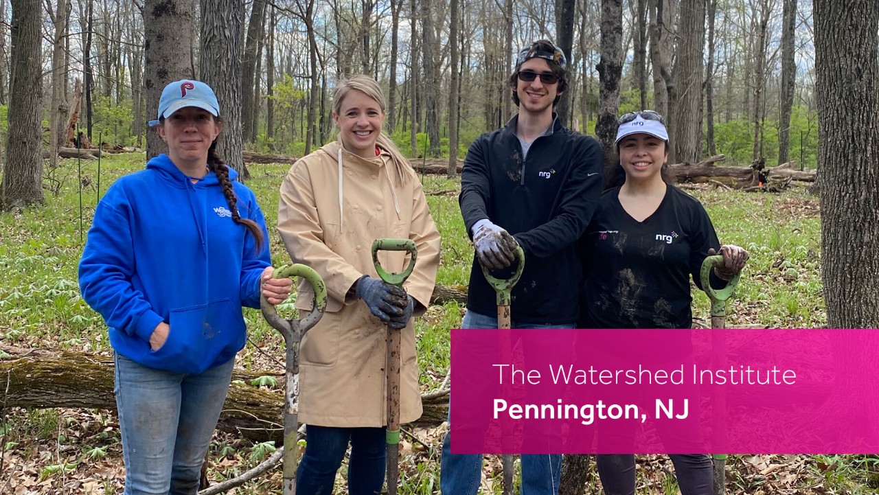 four people with shovels stand in a forest at The Watershed Institute in Pennington, NJ.