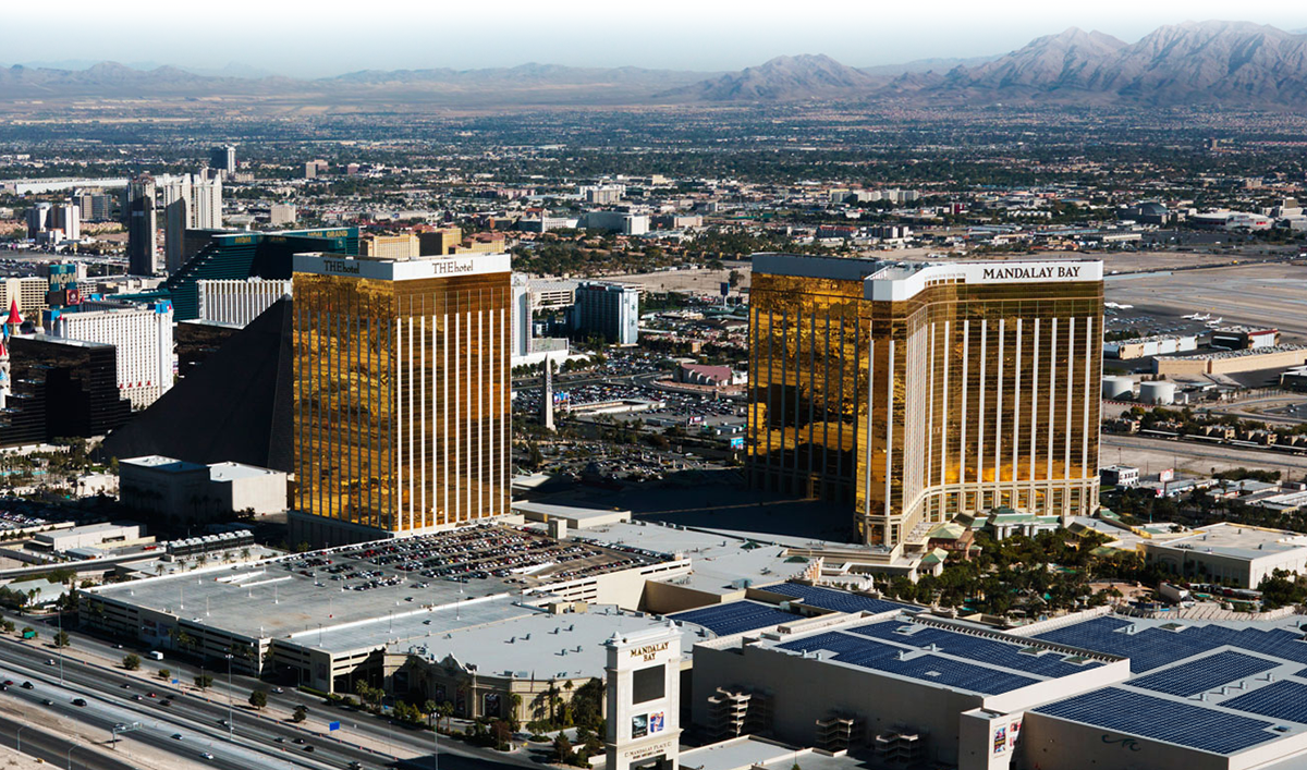 aerial view of Mandalay Bay and Delano hotels in Las Vegas with mountains in the background.